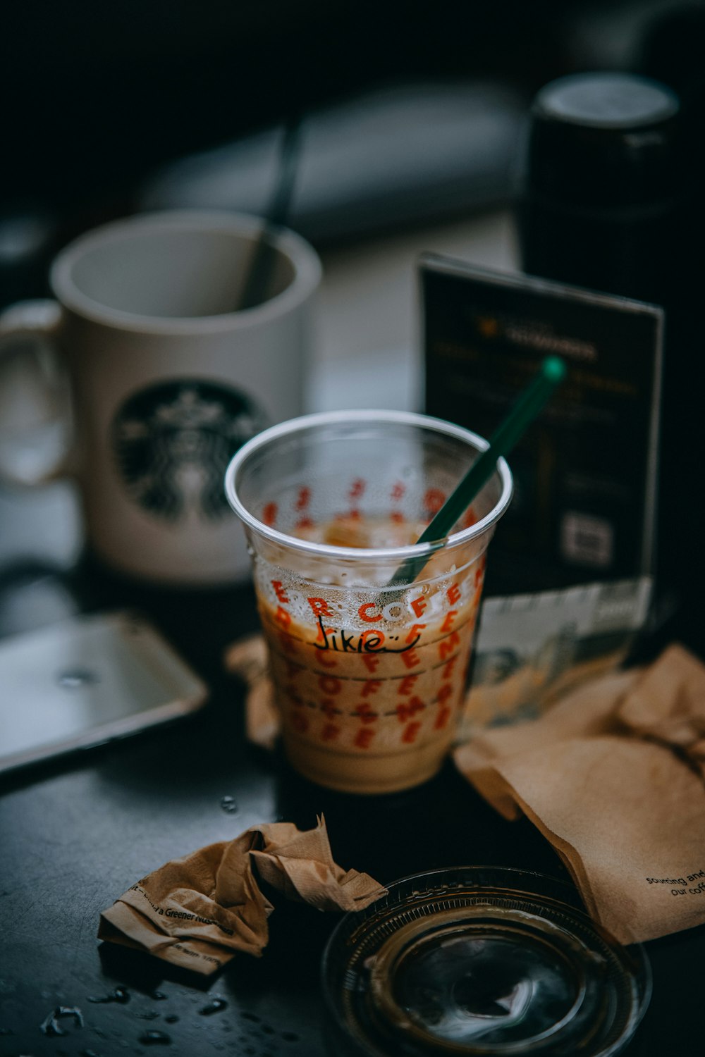 white and red plastic cup with blue straw