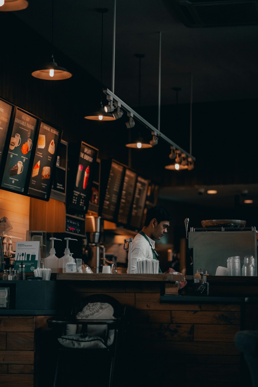 man in white dress shirt standing near counter