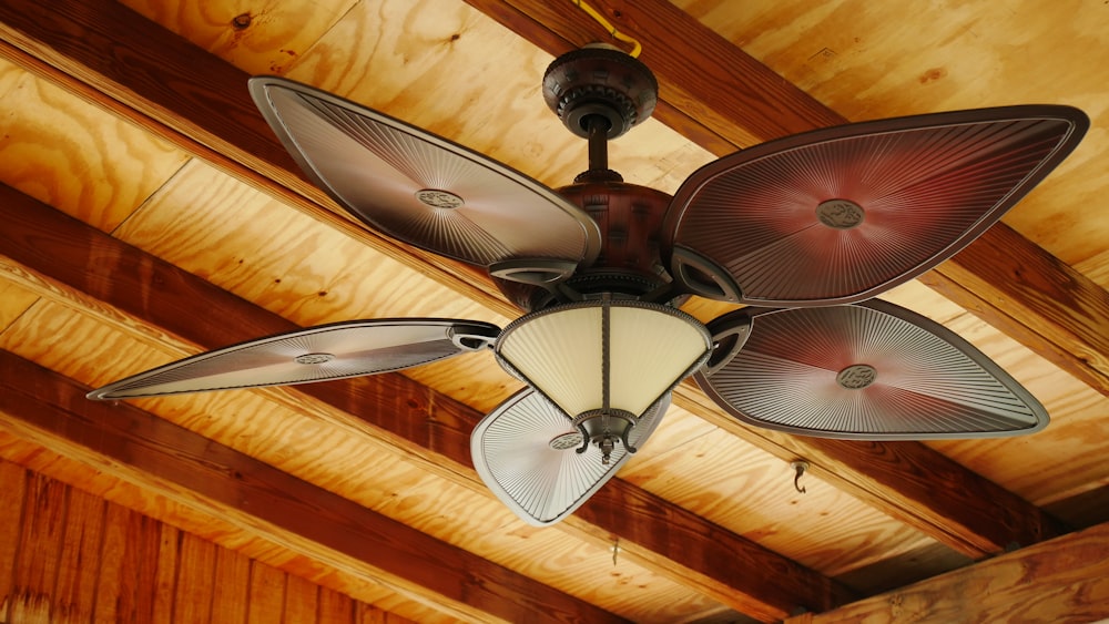 brown and white 5 blade ceiling fan with light fixture