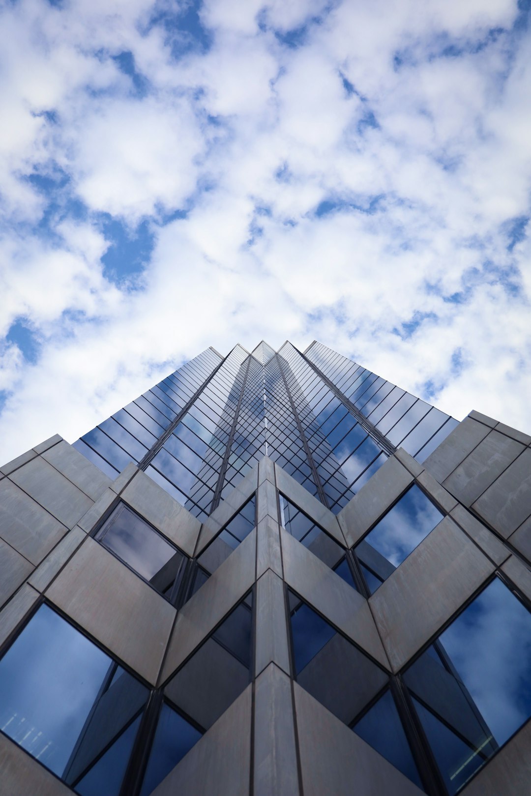 low angle photography of glass building under blue sky during daytime