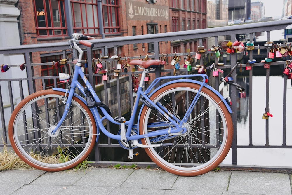 blue bicycle parked beside brown concrete building during daytime