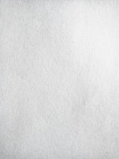A texture of plain white paper with fine grain, slightly uneven surface.