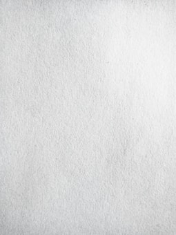 A texture of plain white paper with fine grain, slightly uneven surface.
