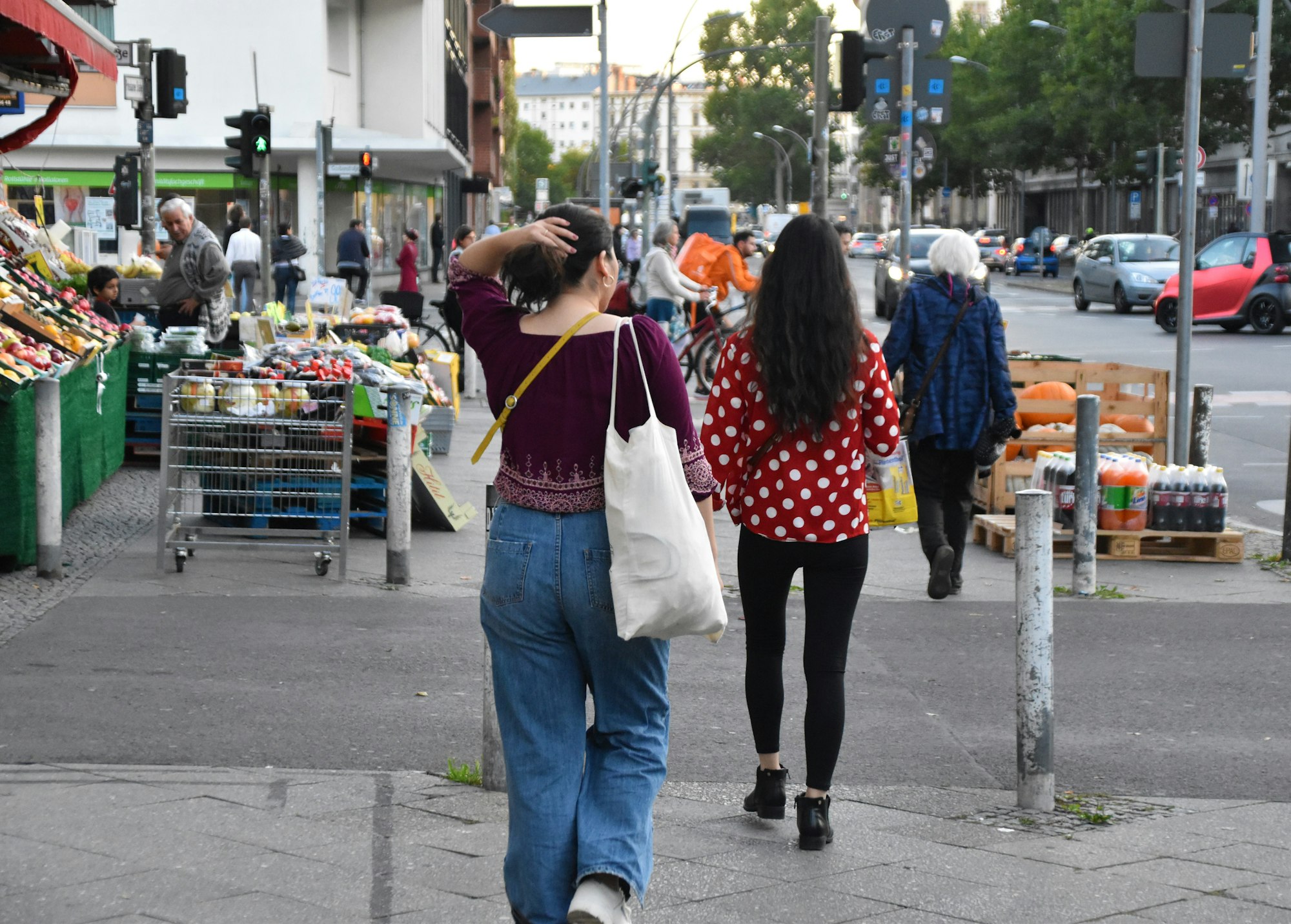 Pedestrians cross a side road