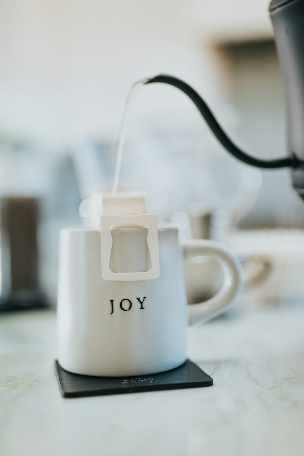 white ceramic mug with silver spoon