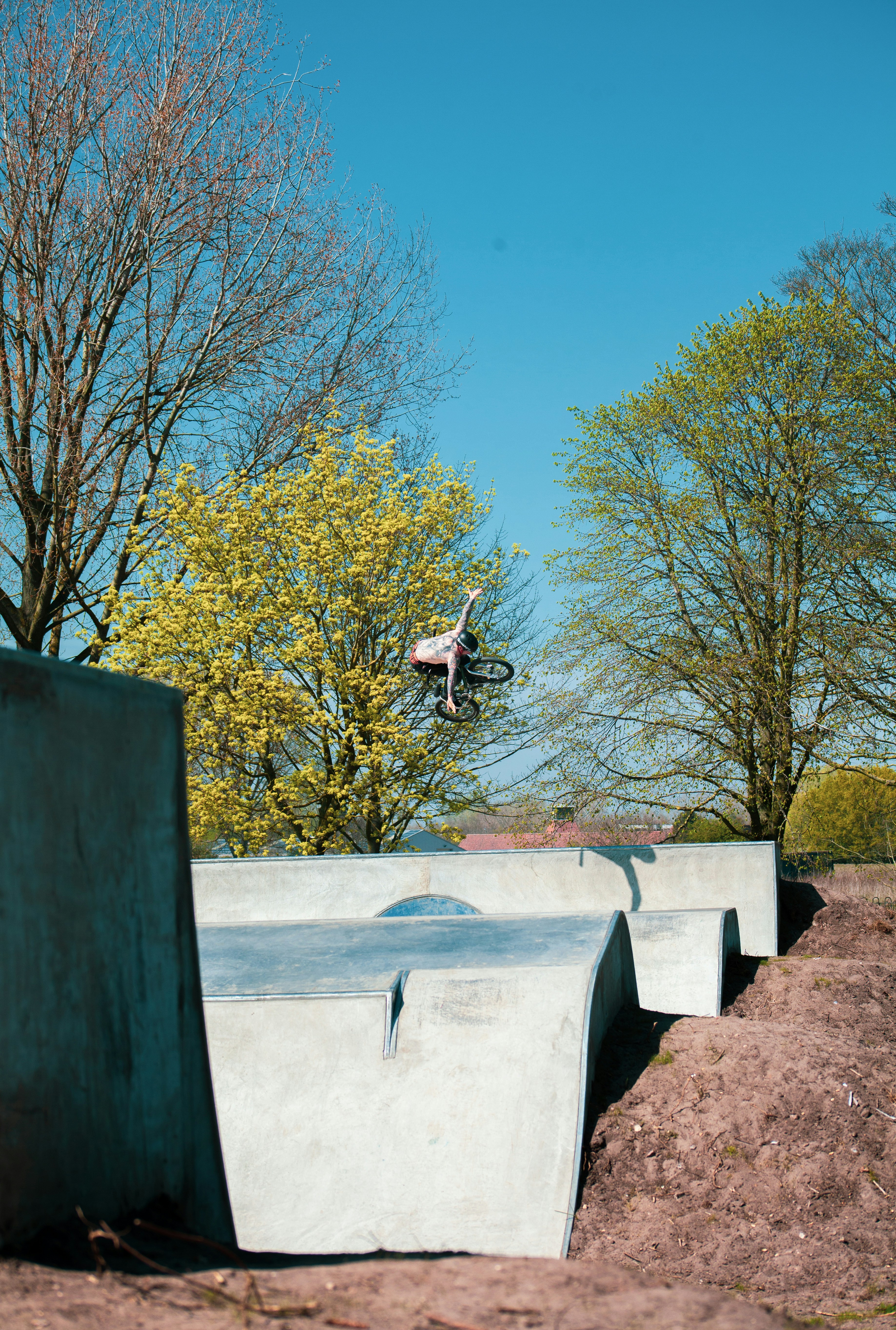 man in black t-shirt and black pants sitting on concrete bench during daytime