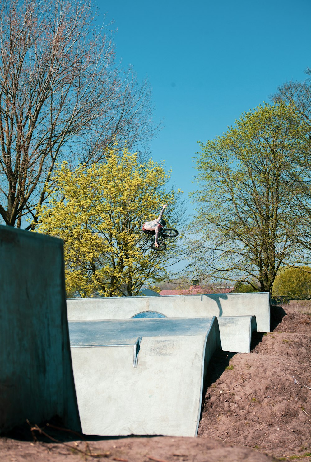 man in black t-shirt and black pants sitting on concrete bench during daytime