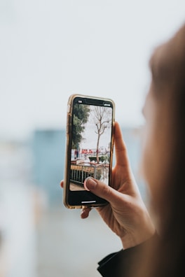 A person using a smartphone outdoors with a clear view.