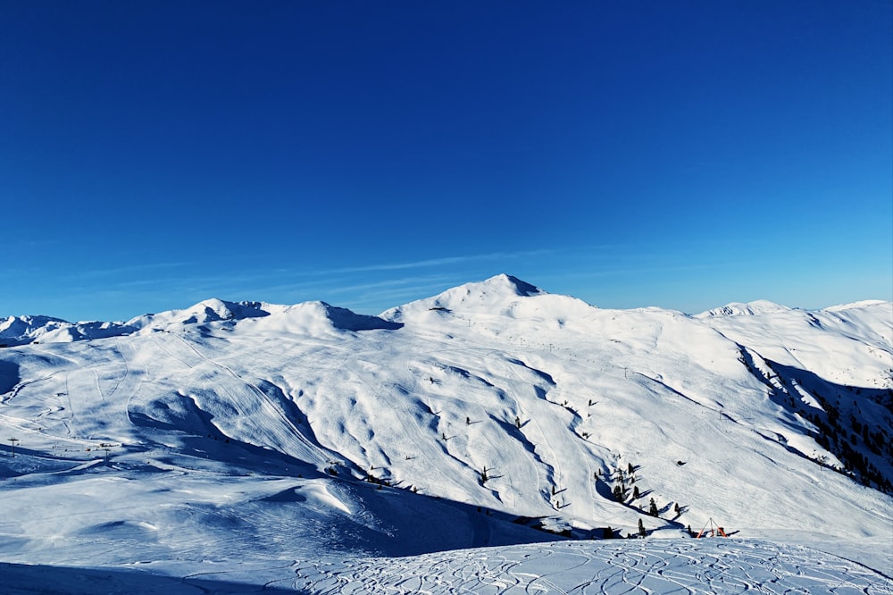 snow covered mountain under blue sky during daytime