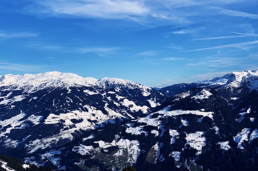 snow covered mountains under blue sky during daytime