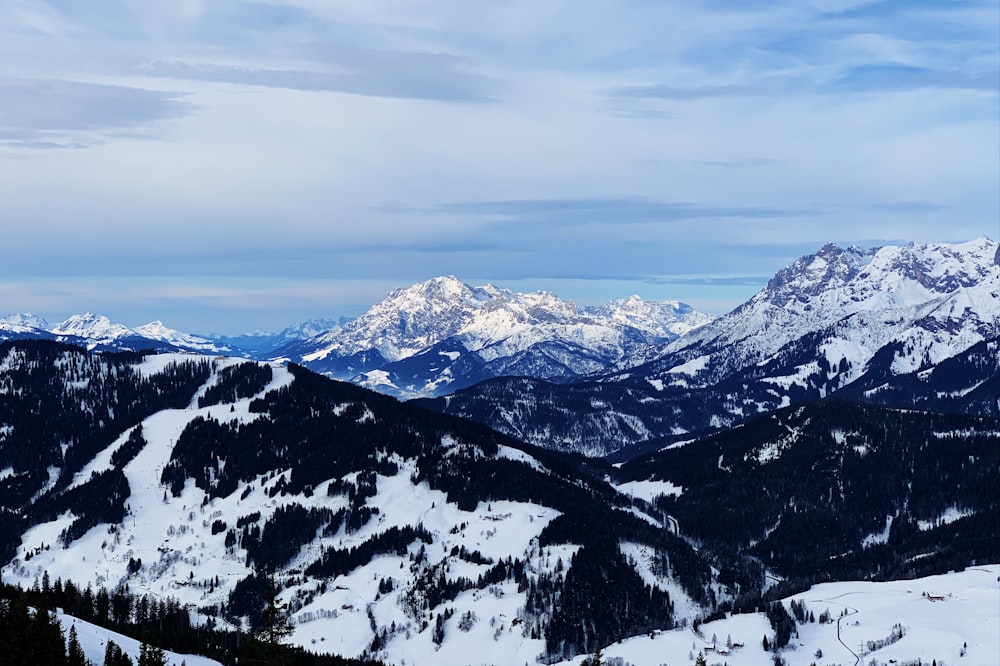 snow covered mountain under cloudy sky during daytime