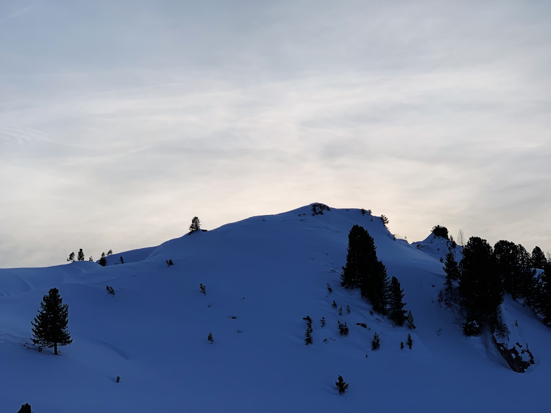 people hiking on snow covered mountain during daytime