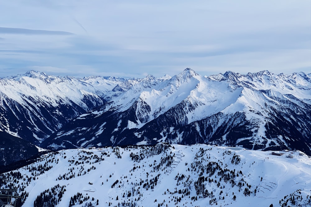 snow covered mountain under cloudy sky during daytime