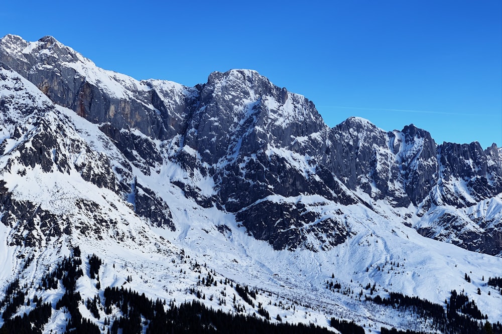 snow covered mountain under blue sky during daytime