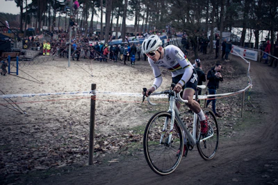 A cyclist racing through a scenic route with intense focus