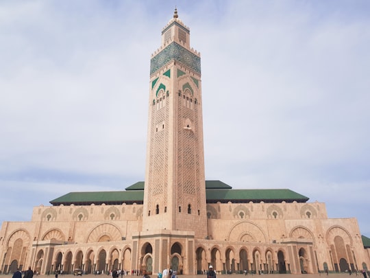 brown concrete building under blue sky during daytime in Hassan II Mosque Morocco