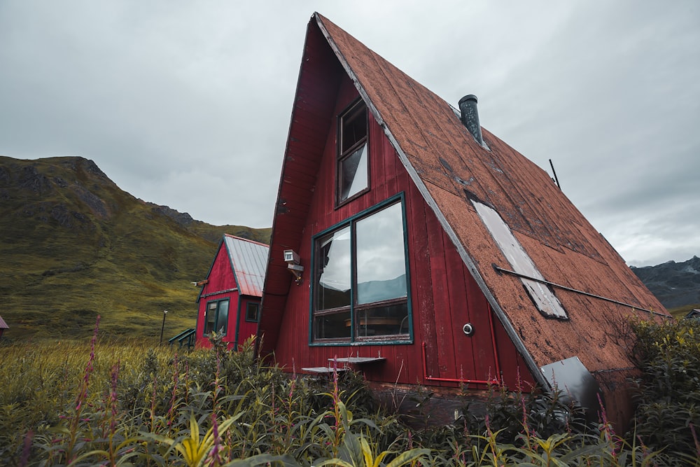 red and brown wooden barn house on green grass field