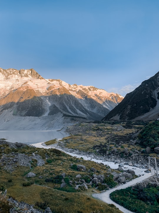 snow covered mountains under blue sky during daytime in Aoraki/Mount Cook National Park New Zealand