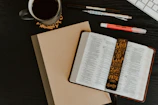Colorful bookmarks and Bible study materials spread out on a wooden desk.