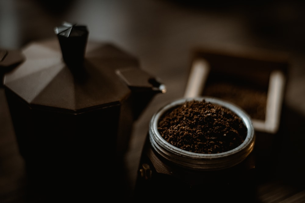 black coffee beans in black and silver coffee maker