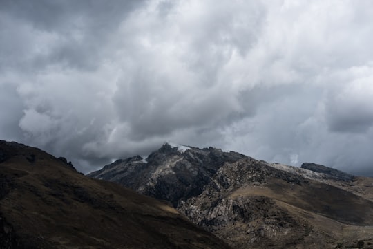 brown and green mountains under white clouds during daytime in Huaraz Peru