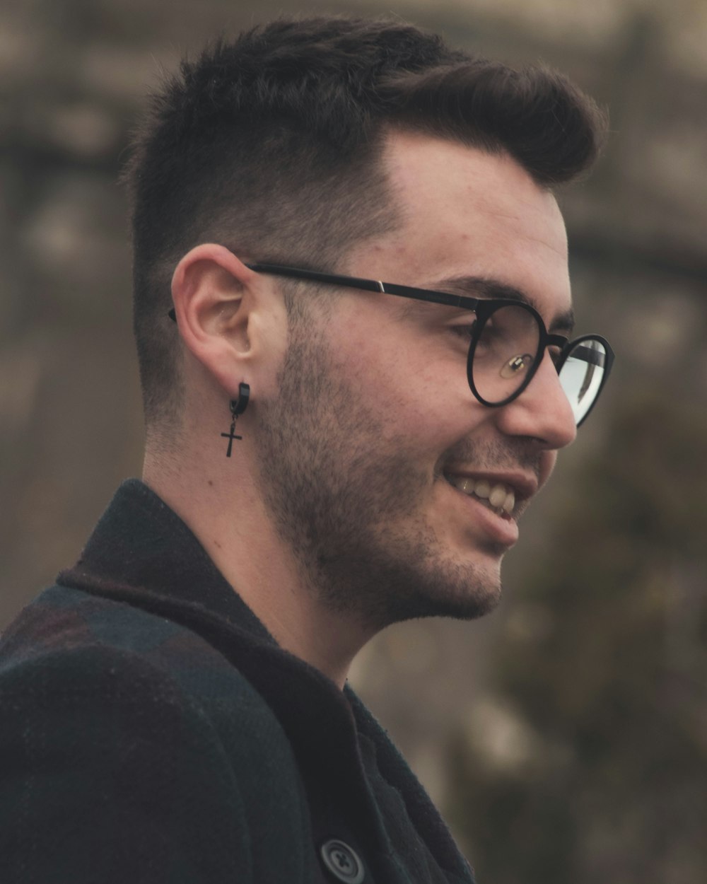 man in black framed eyeglasses and black shirt