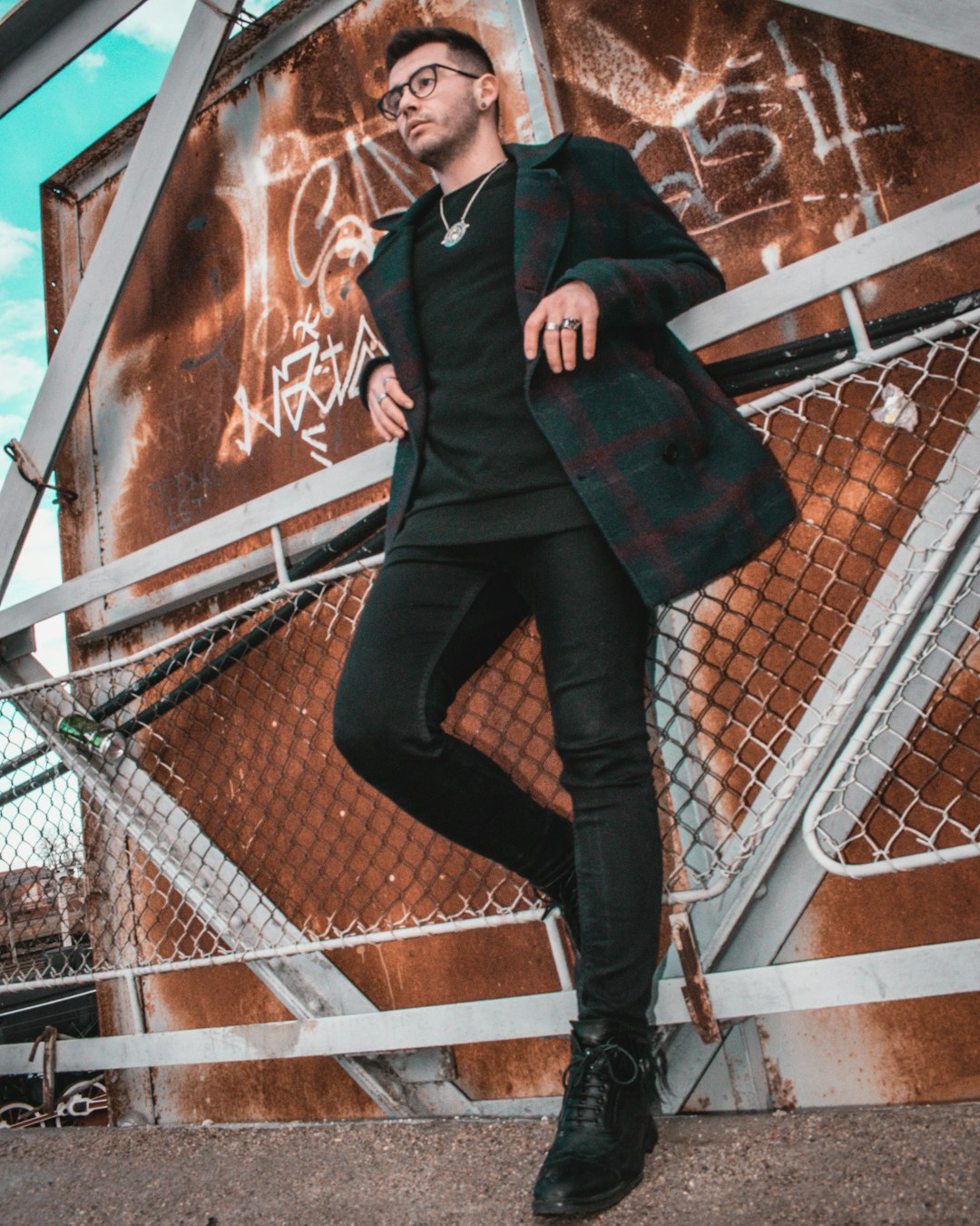 woman in black leather jacket and black pants standing on stairs