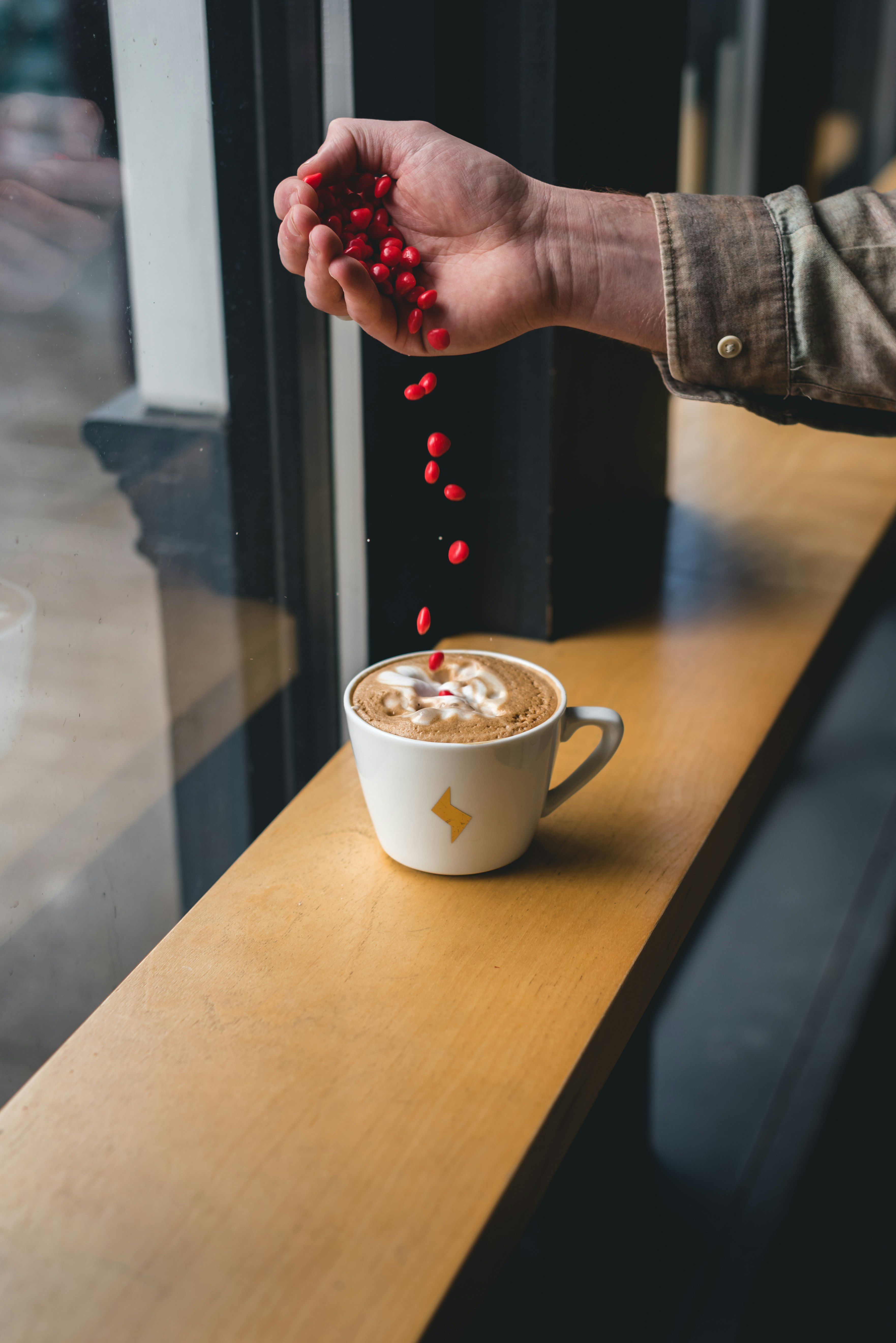 person holding white ceramic mug with coffee