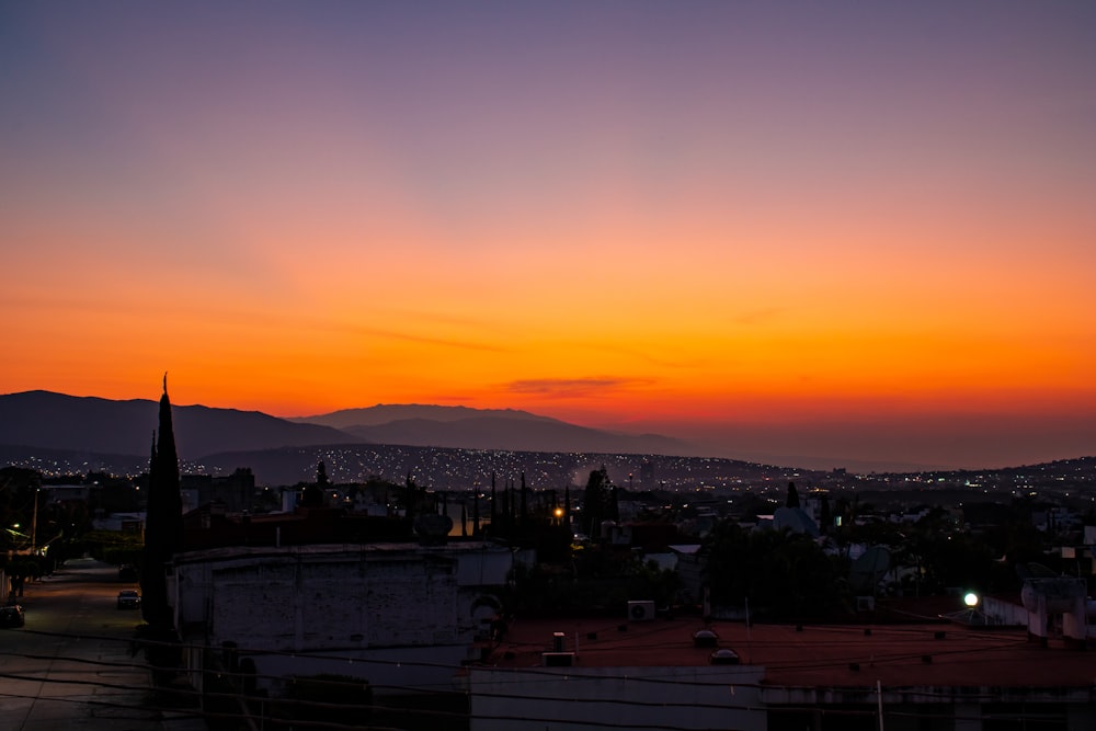 city skyline during sunset with orange sky