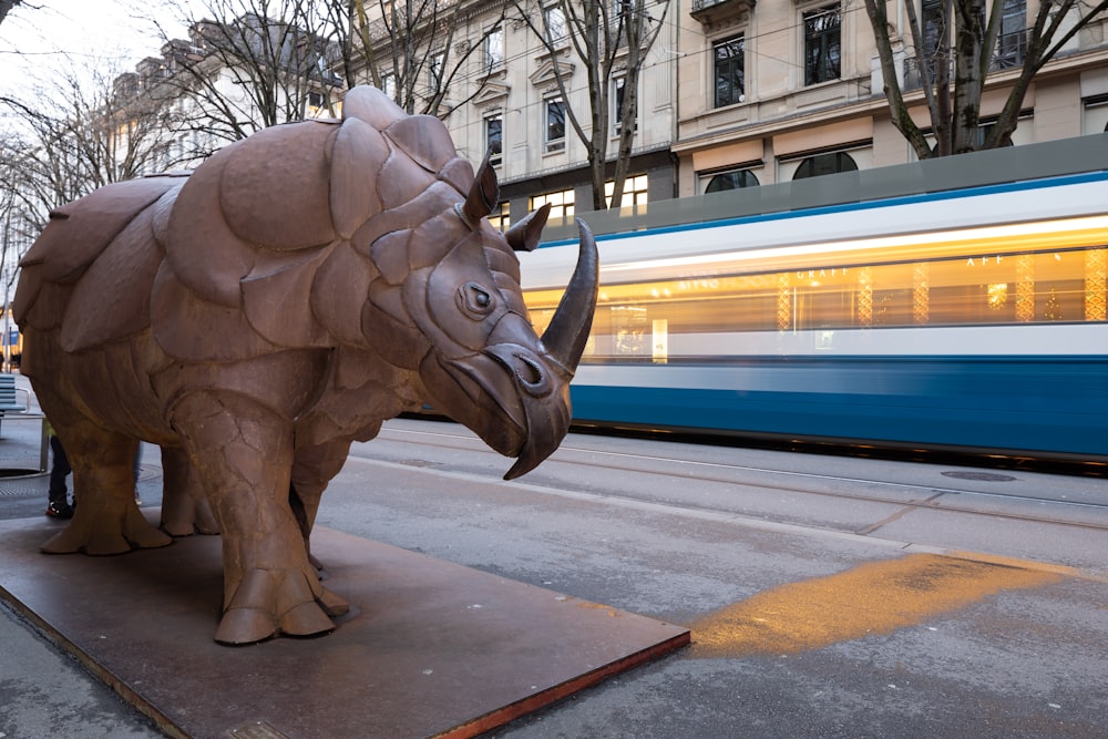 brown elephant statue near white building during daytime