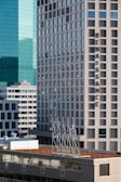 High-rise buildings with modern architectural design dominate the skyline. The word 'Renaissance' is prominently displayed on one of the buildings. The structures feature a mix of glass and concrete, reflecting light and casting shadows. Several floors are visible, with a distinctive grid-like pattern of windows.