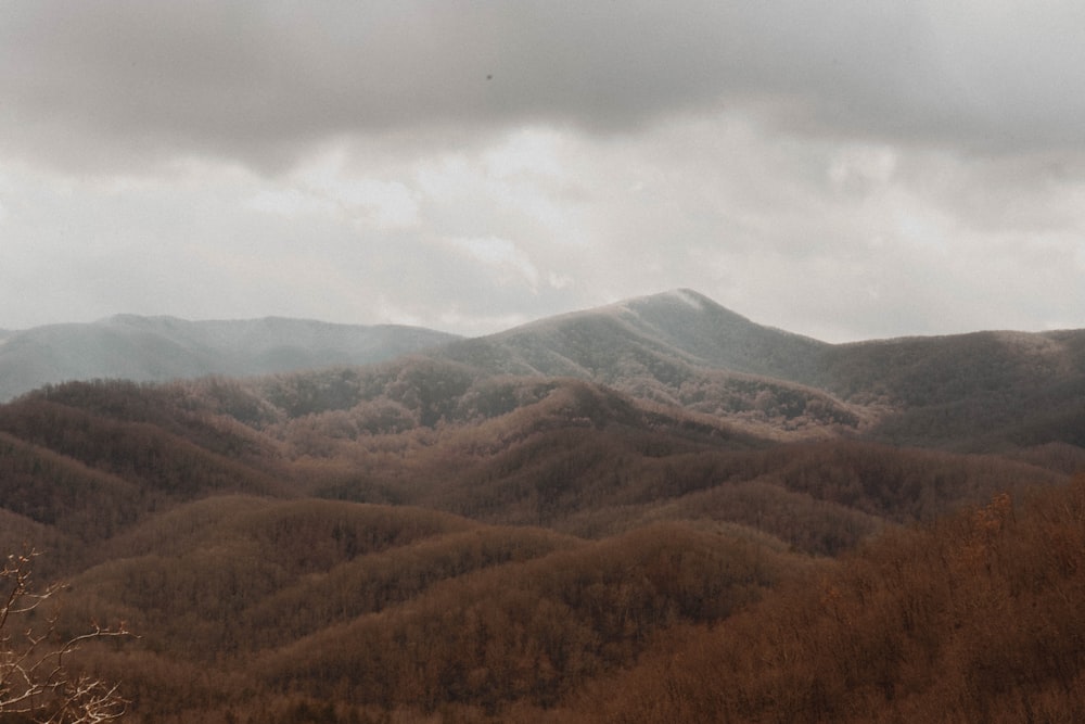 green and brown mountains under white clouds during daytime