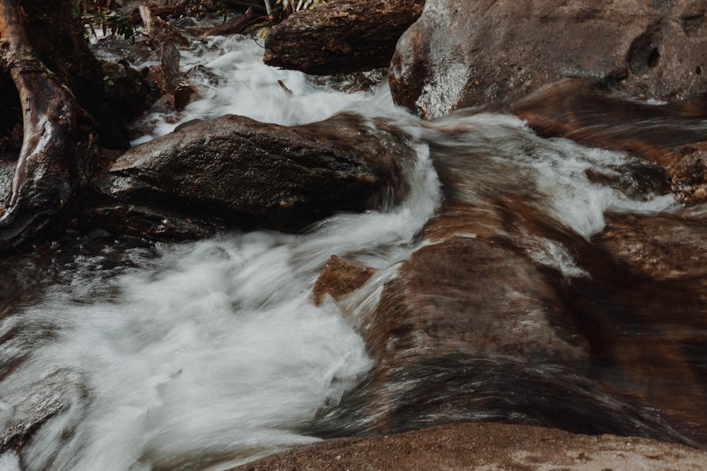 water falls on brown rocky mountain