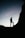 silhouette of man standing on rock during sunset