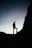 silhouette of man standing on rock during sunset