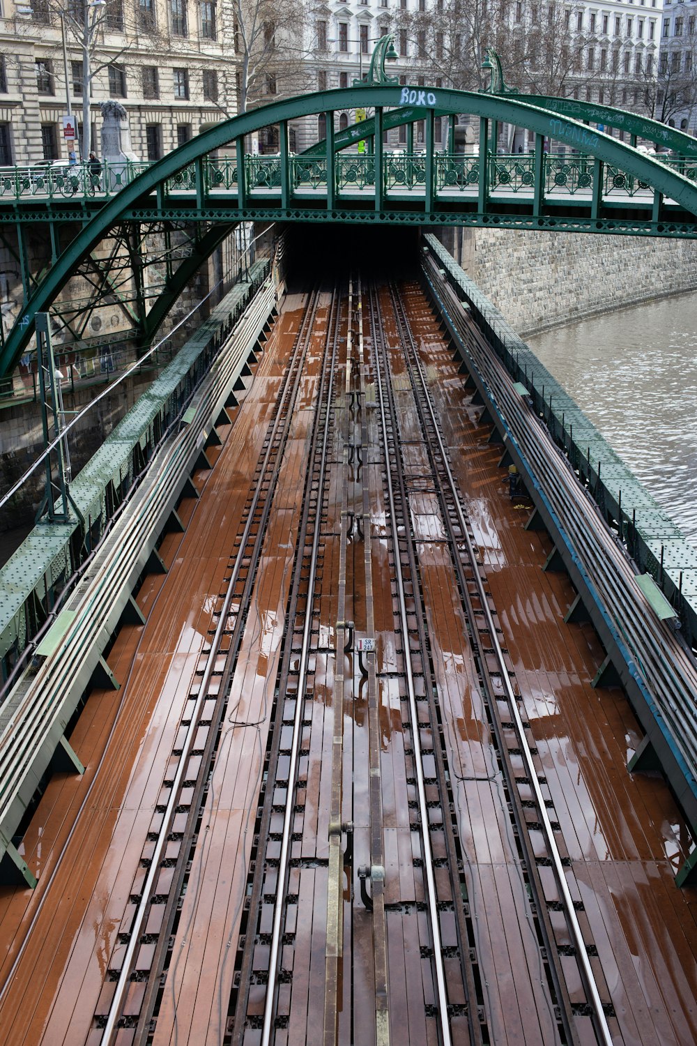 rail de train près d’un plan d’eau pendant la journée