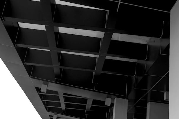 Abstract architectural detail showcasing sharp angles and shadows in monochrome.