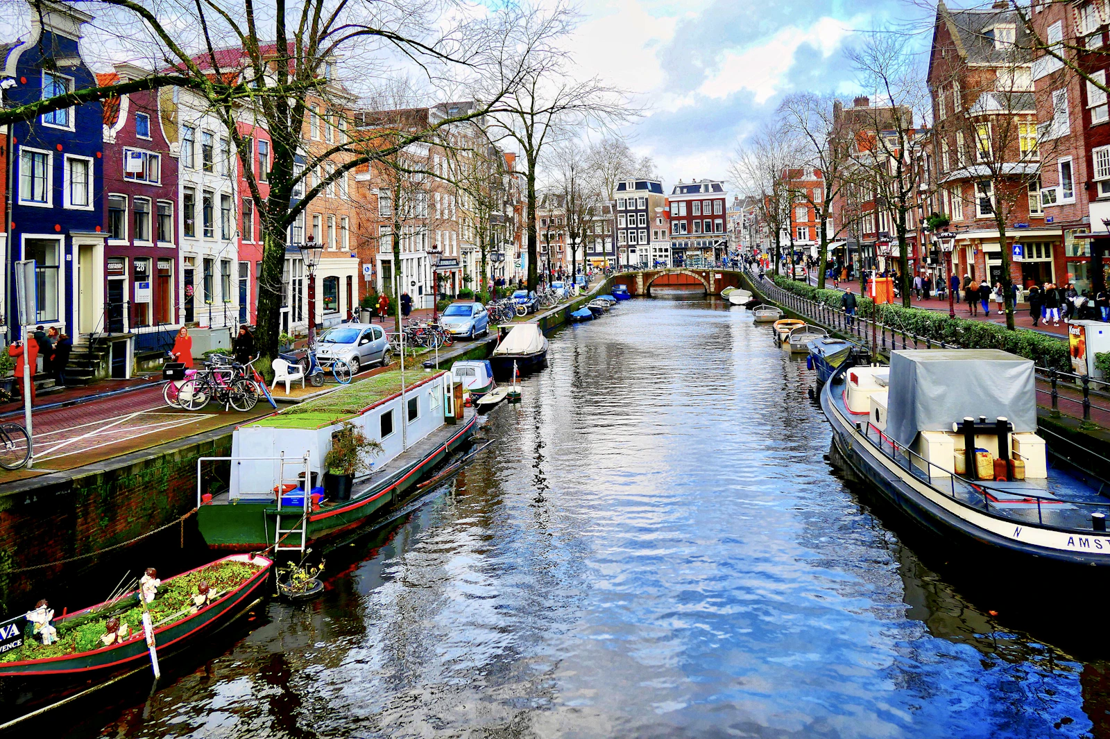 Boat passing Amsterdam canal houses during a photography walk