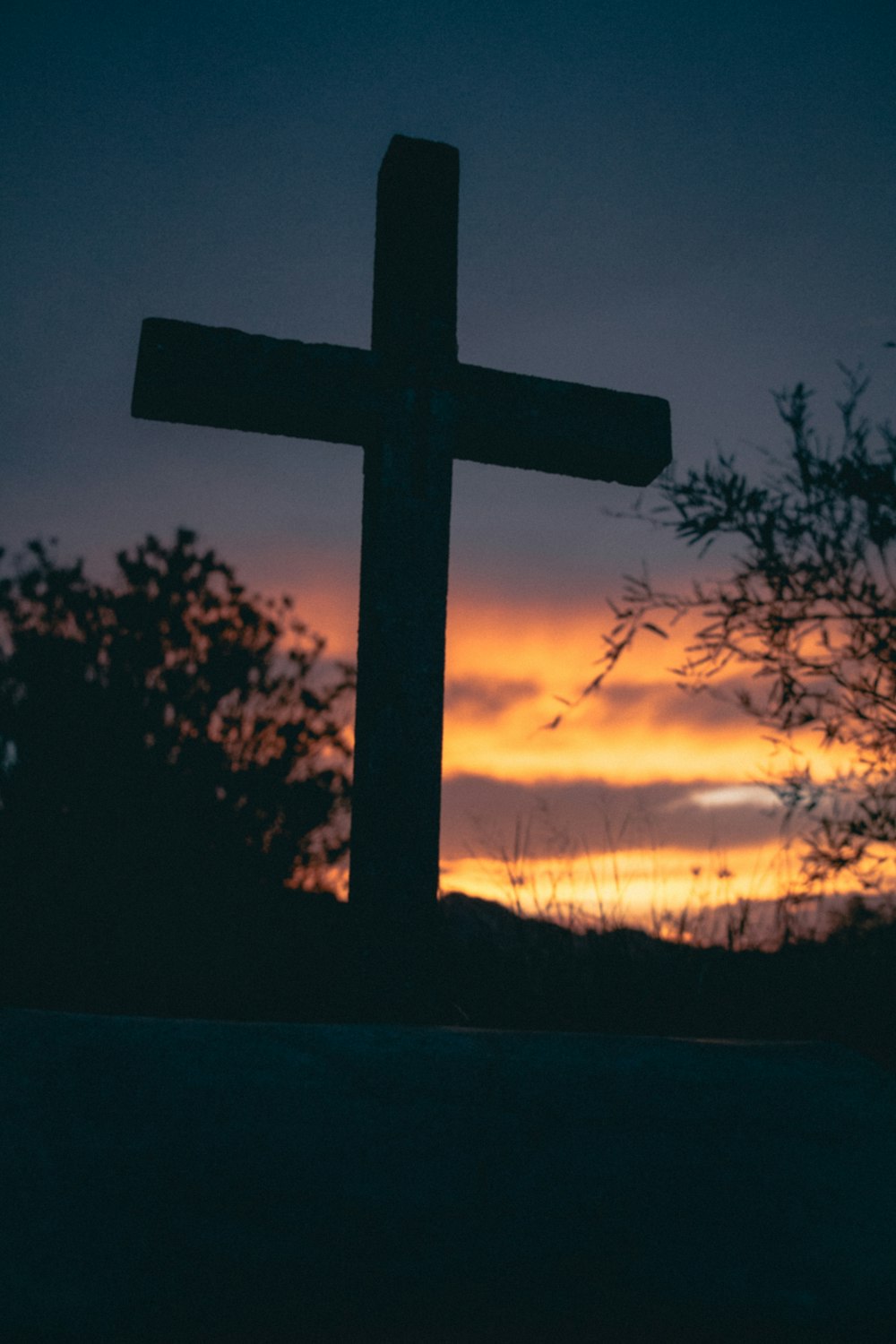 silhouette of cross during sunset