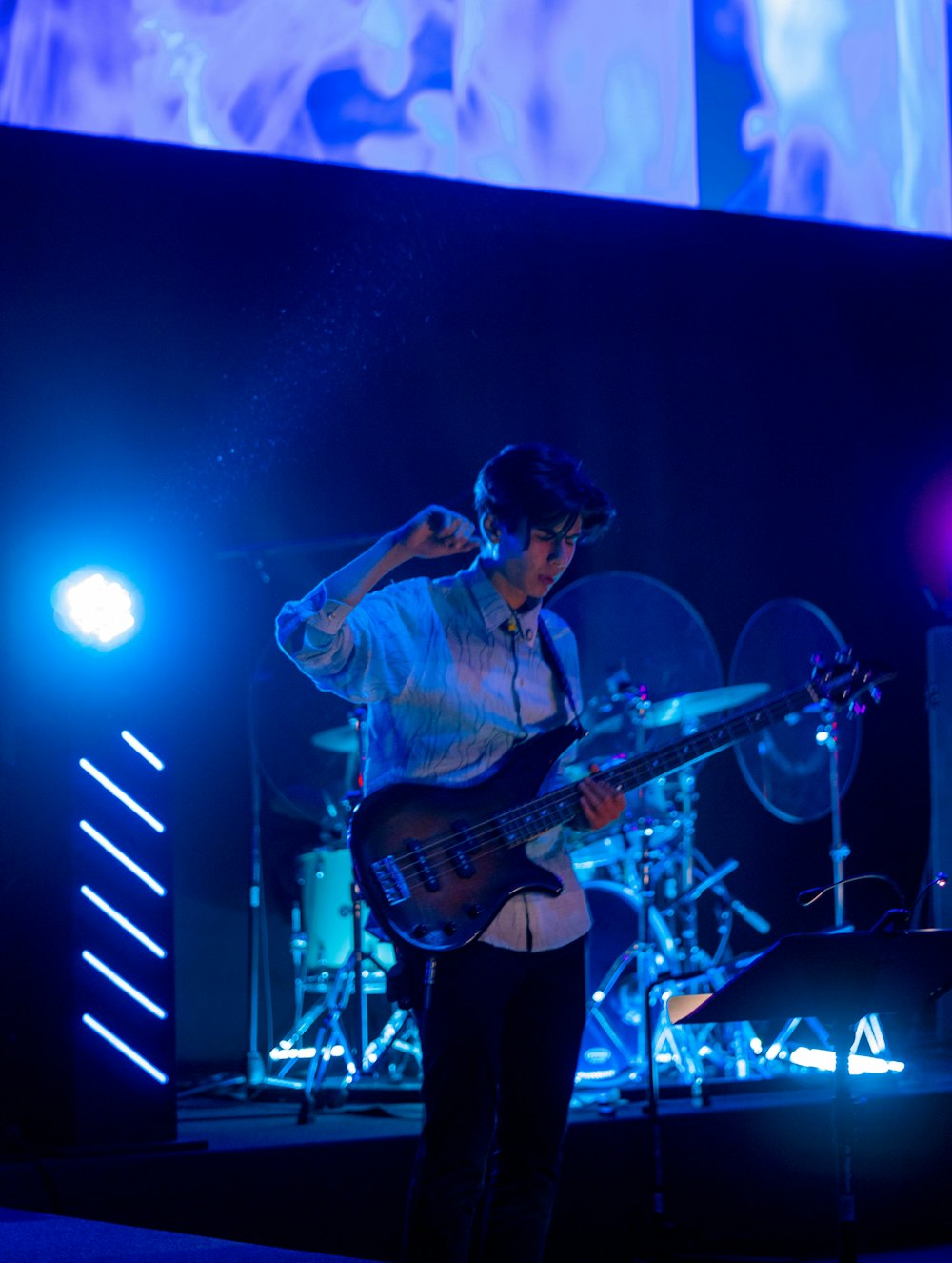 man playing electric guitar on stage