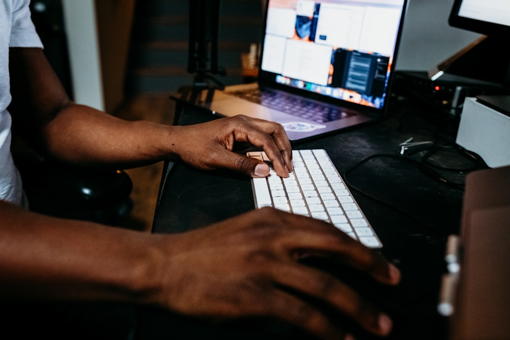 person using white and black laptop computer