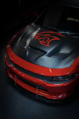 Side view of a Mustang featuring a custom aggressive black and burnt sienna wrap design.