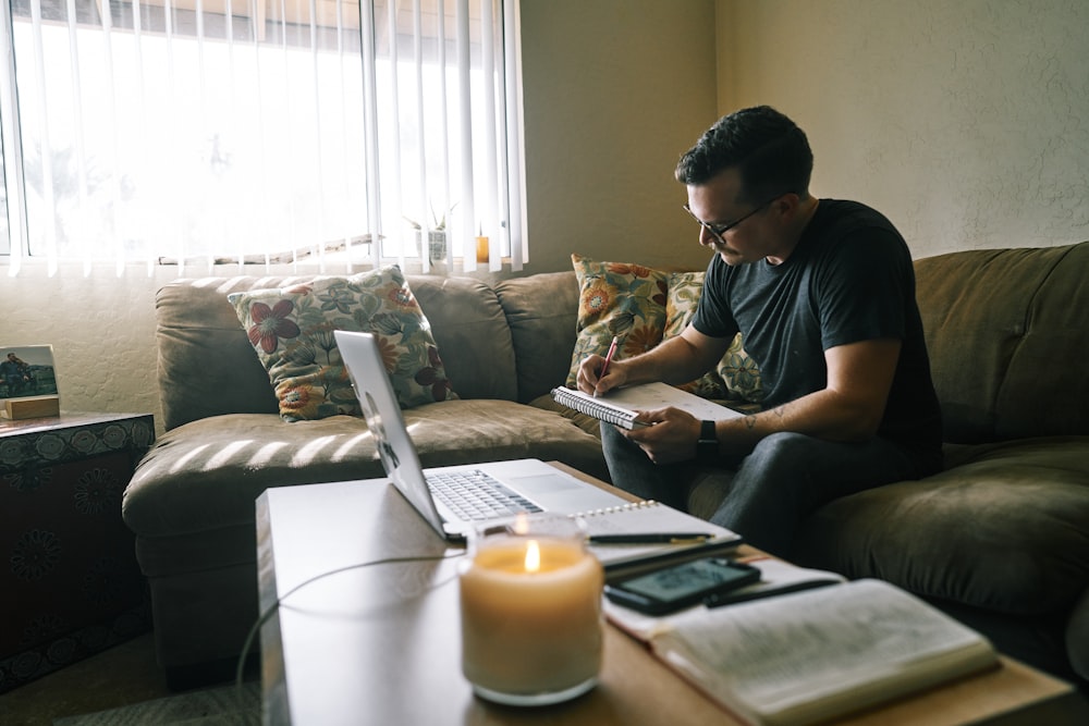 man in black crew neck t-shirt sitting on couch