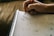 A close-up of a designer's hands sketching ideas on a notepad, illustrating the creative process.