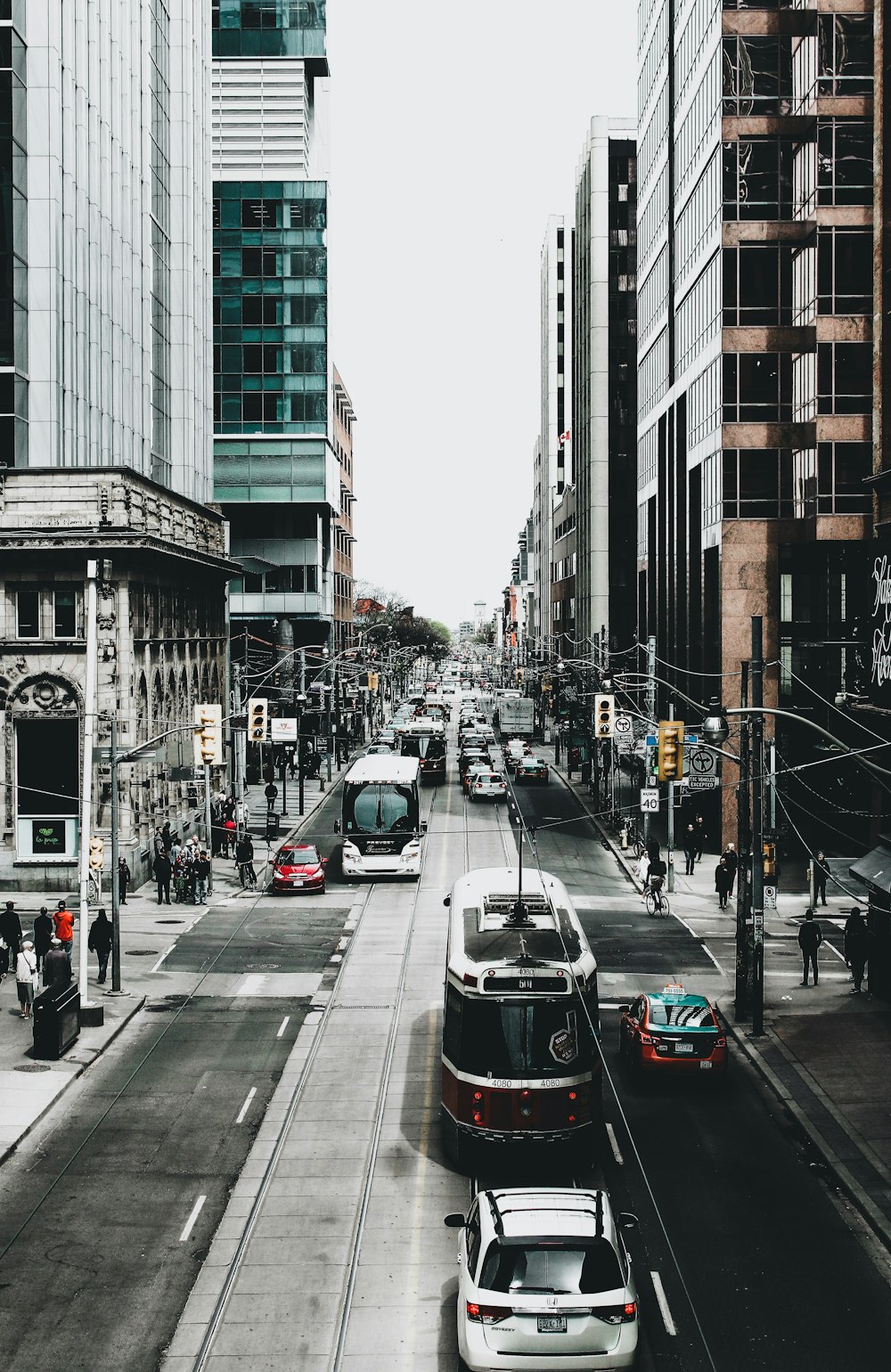 cars on road between buildings during daytime