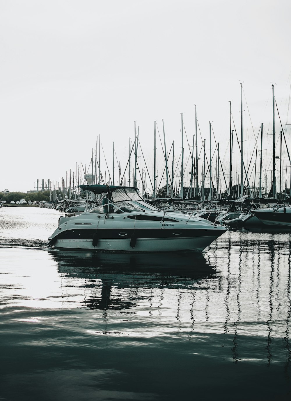 white and blue boat on water during daytime