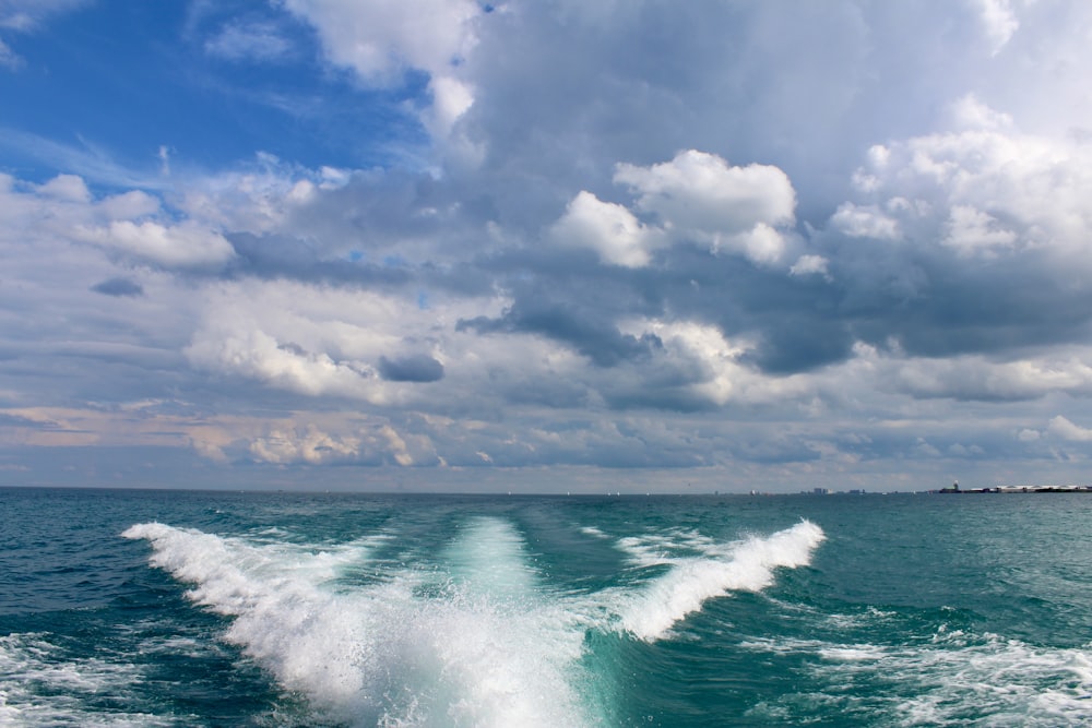 ocean waves under cloudy sky during daytime