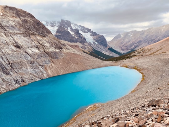 blue lake surrounded by rocky mountains during daytime in Cerro Castillo Chile