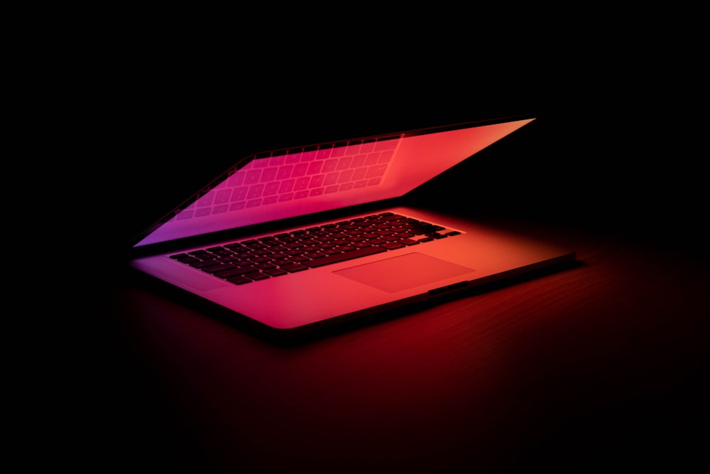 macbook pro on brown wooden table