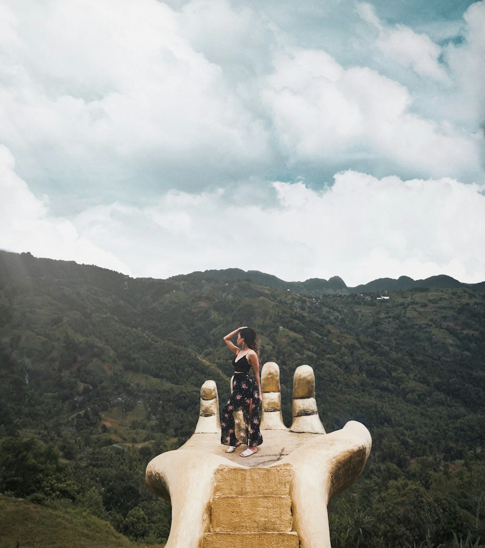 couple sitting on rock formation during daytime